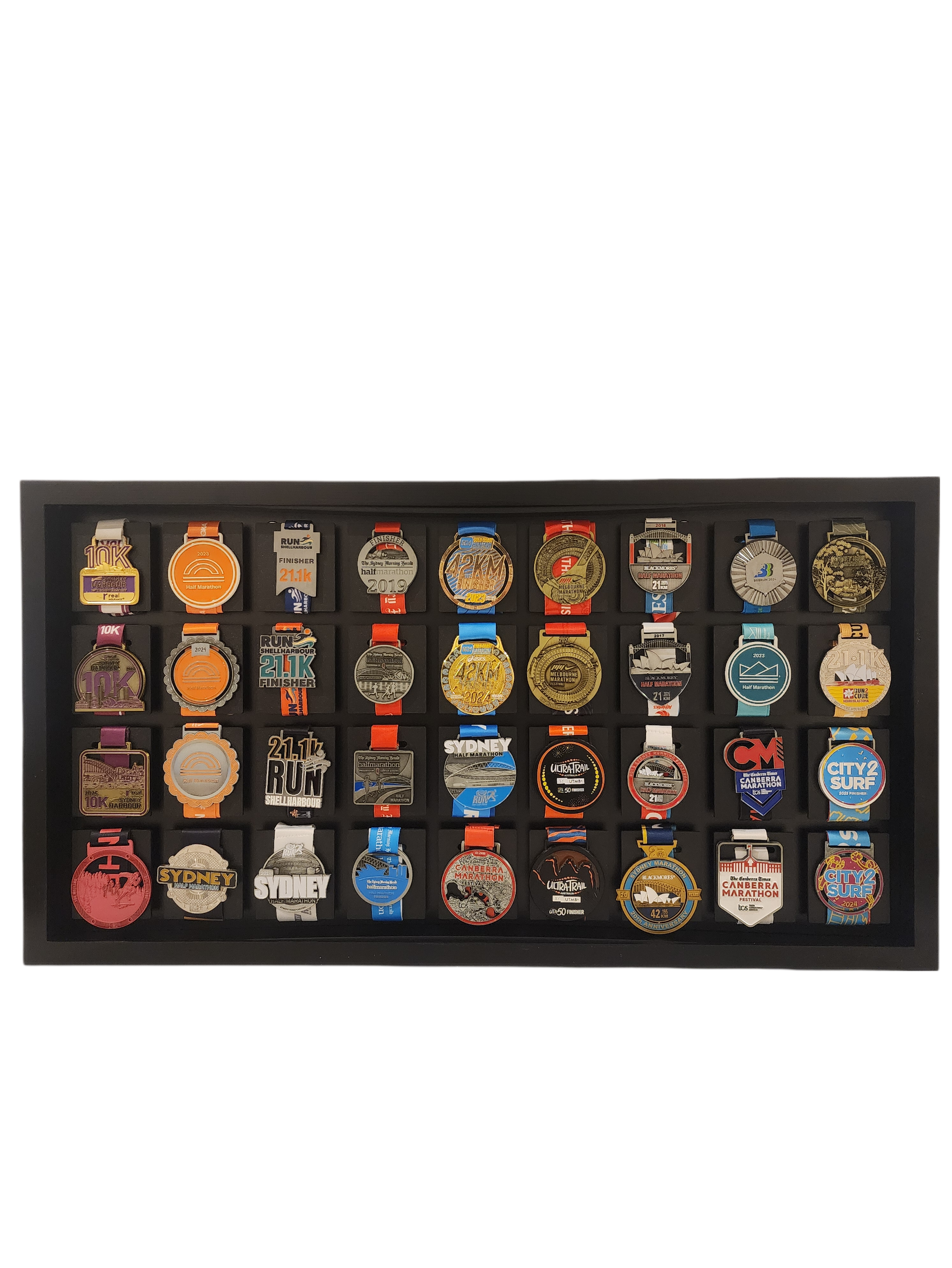 Collection of various medals displayed in a black frame on a white background