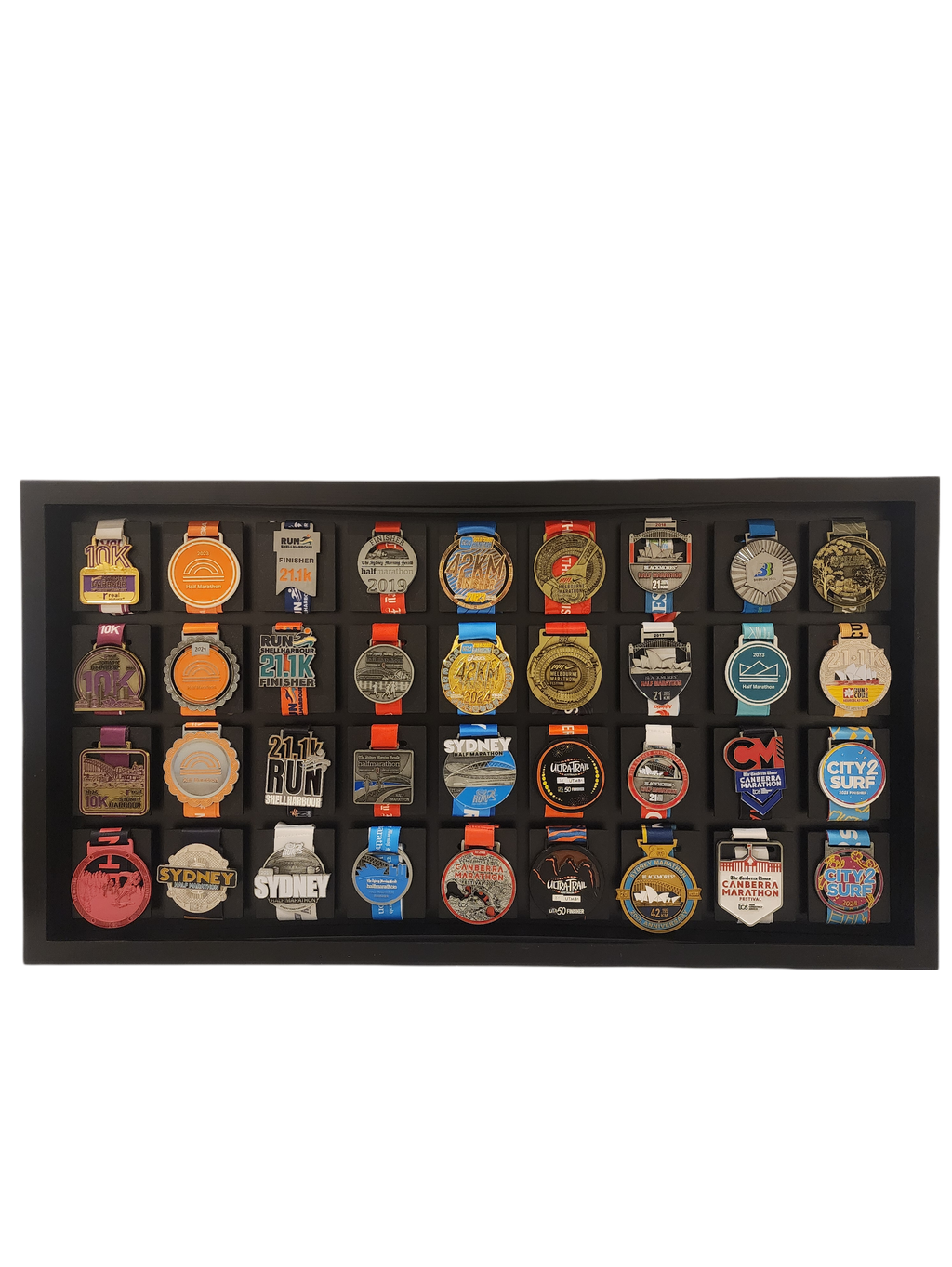 Collection of various medals displayed in a black frame on a white background